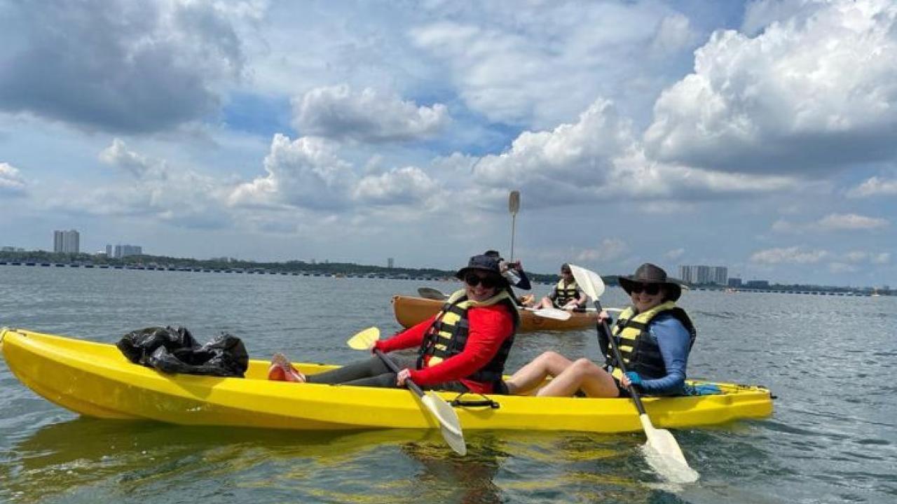 Two people paddling a canoe.