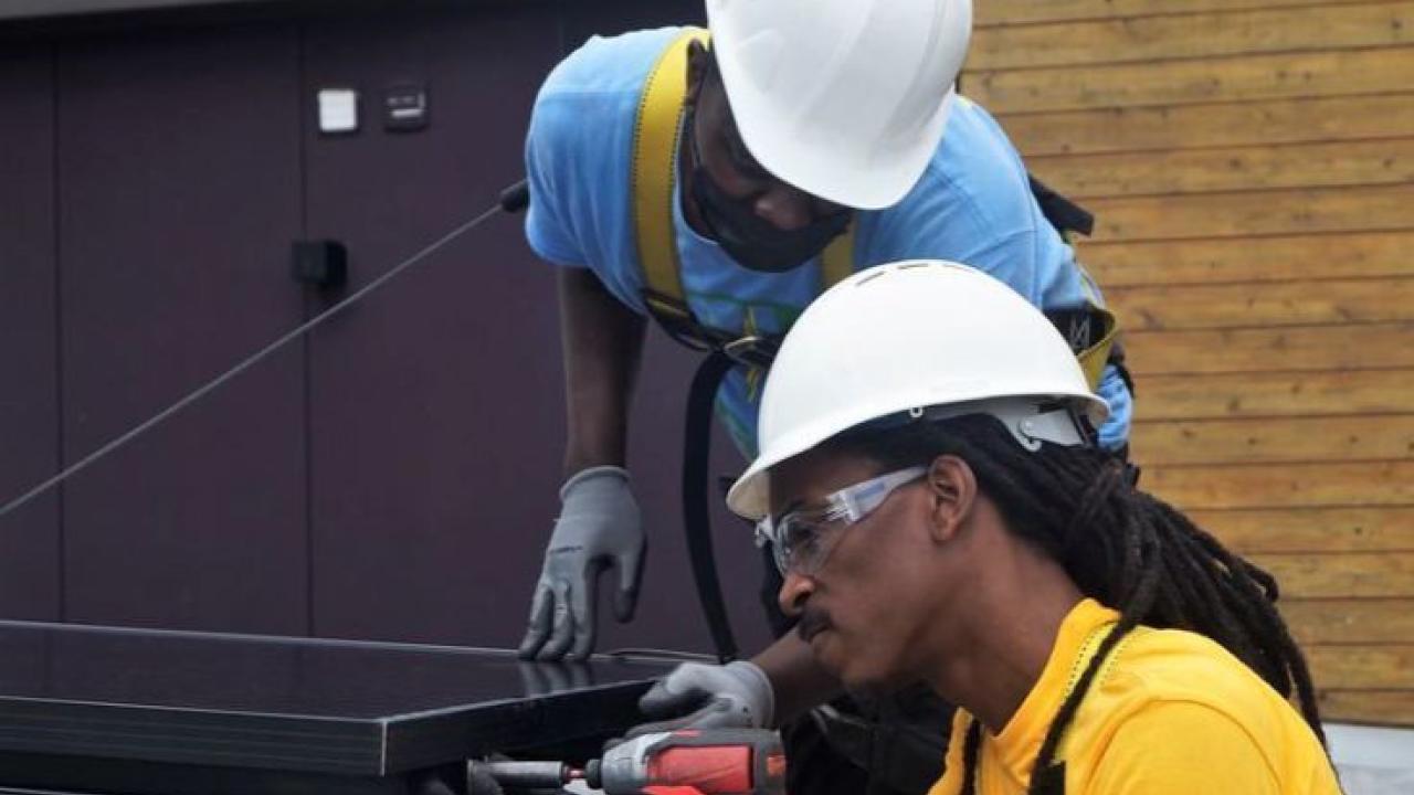 Workers installing solar panels.