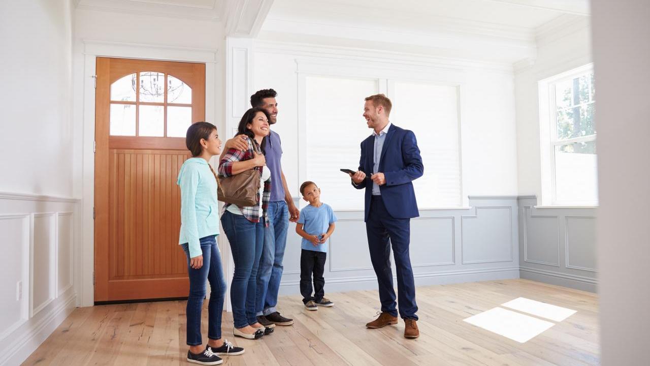 Photo of family touring a house for possible purchase.
