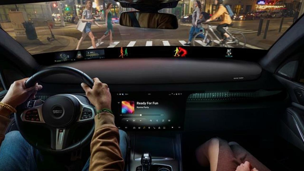 A couple seated in a car with the information system shown.