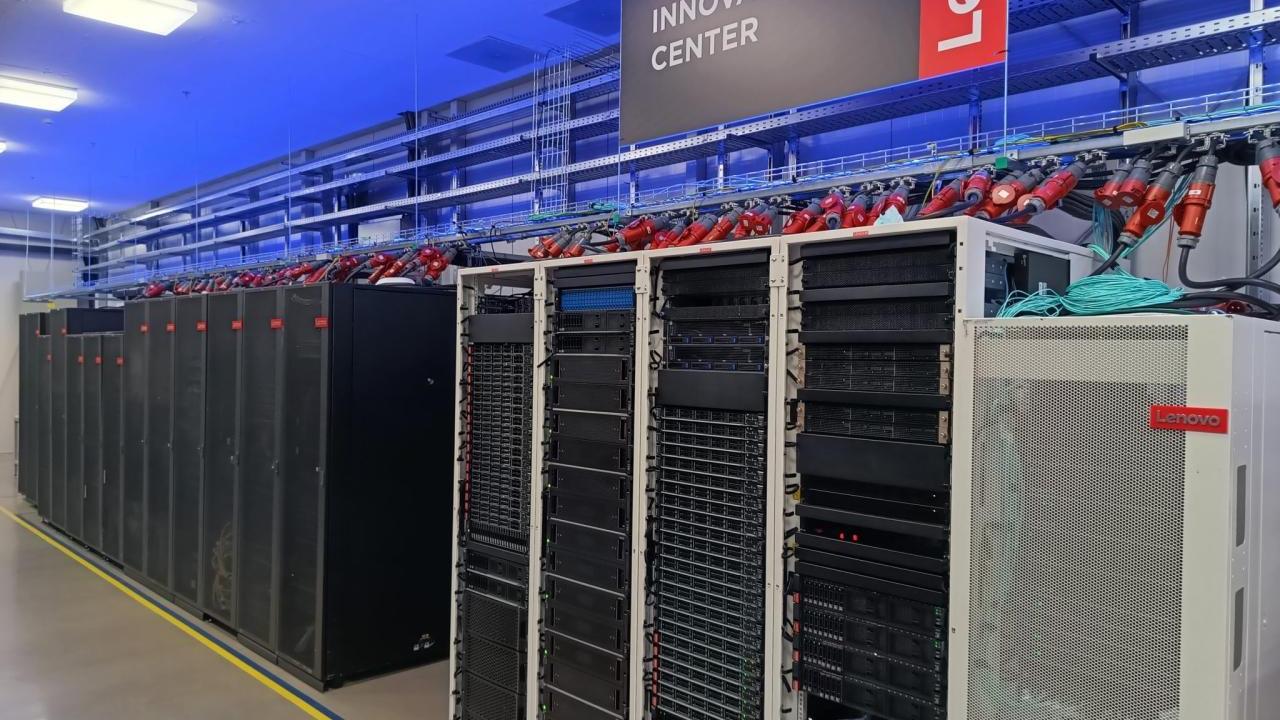 Row of tall servers and tech devices. A lenovo Innovation Center banner overhead.