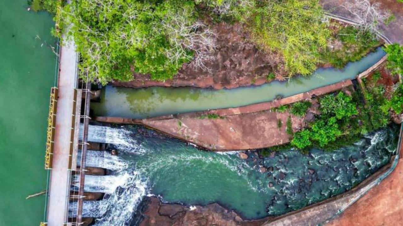 Aerial view of water running through a dam
