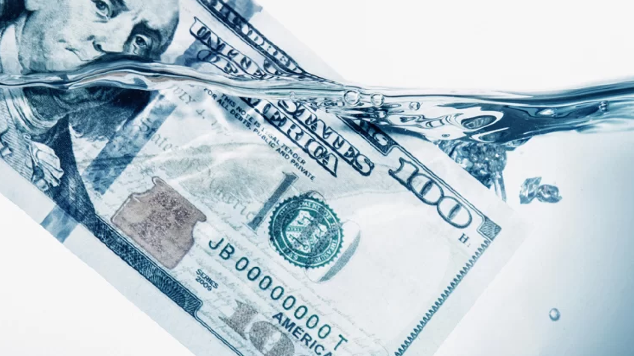 100 dollar bill dipped in water
