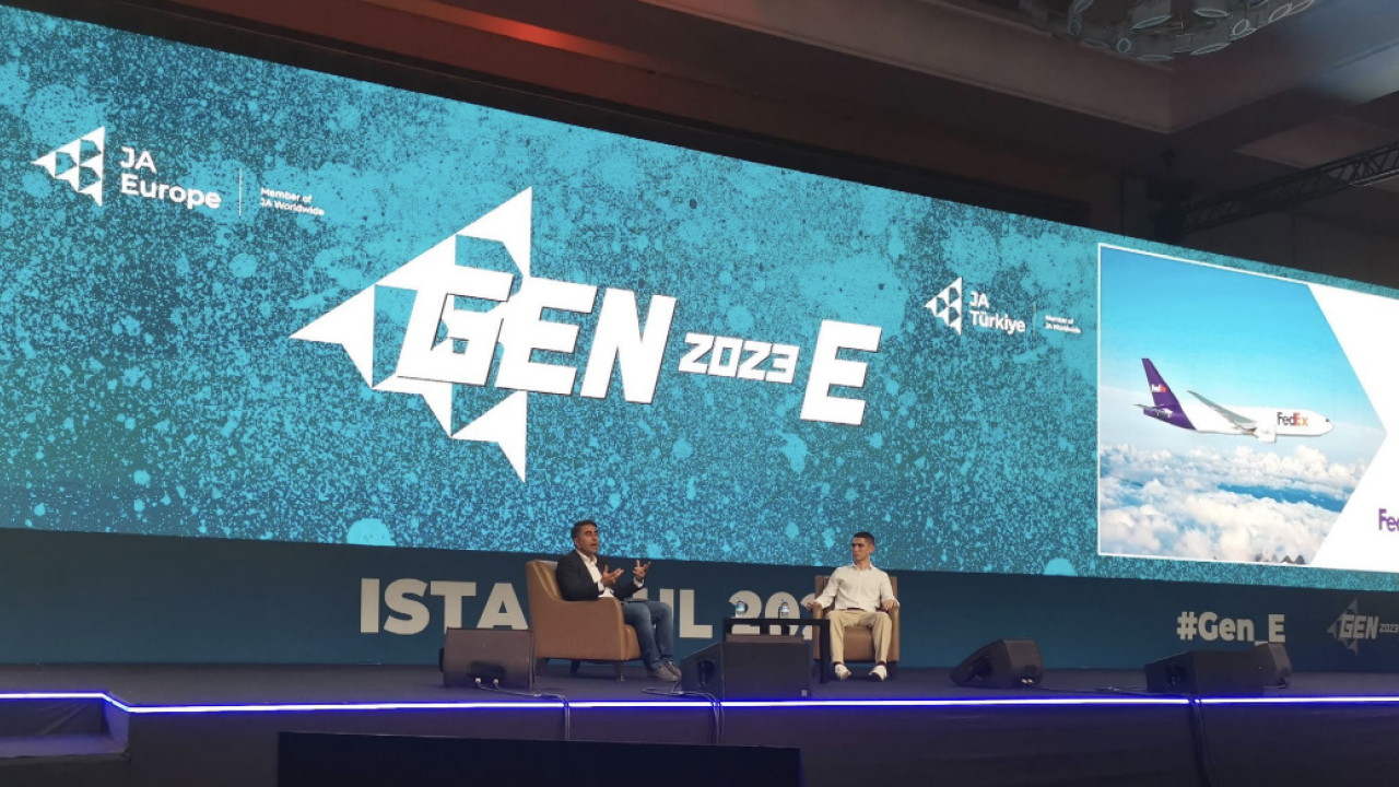 Two people on stage having a discussion at the GEN-E European Entrepreneurship Festival,
