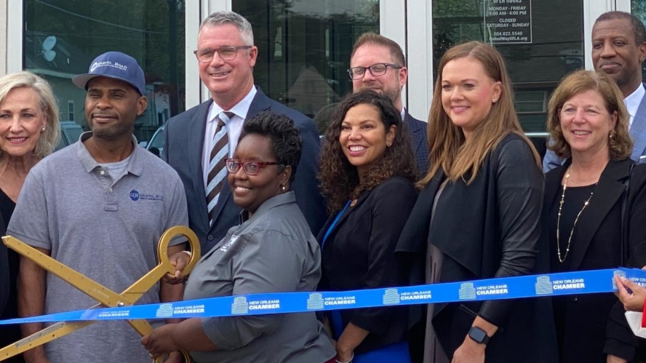 group performing ribbon cutting 