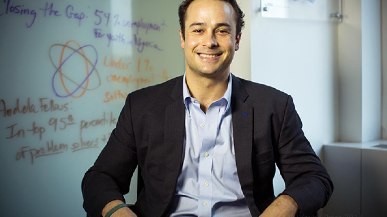 Man in dress shirt and blazer smiling