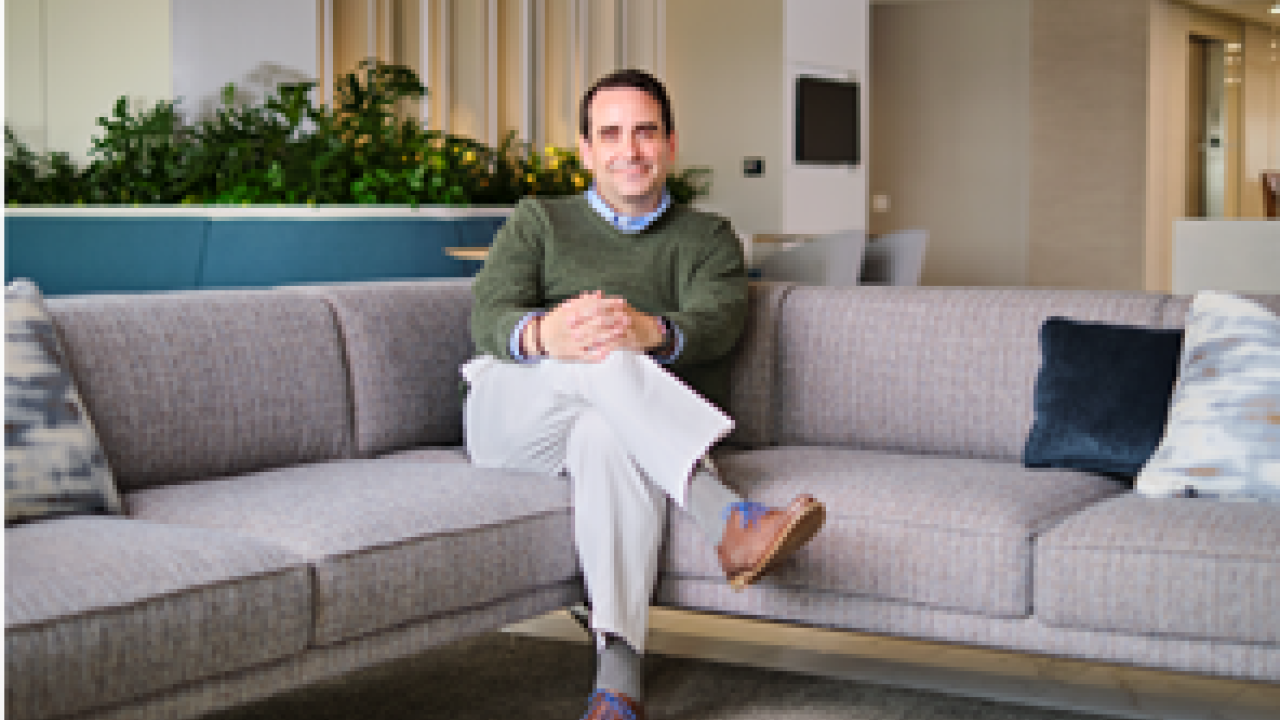 Person with hands and legs crossed on a couch