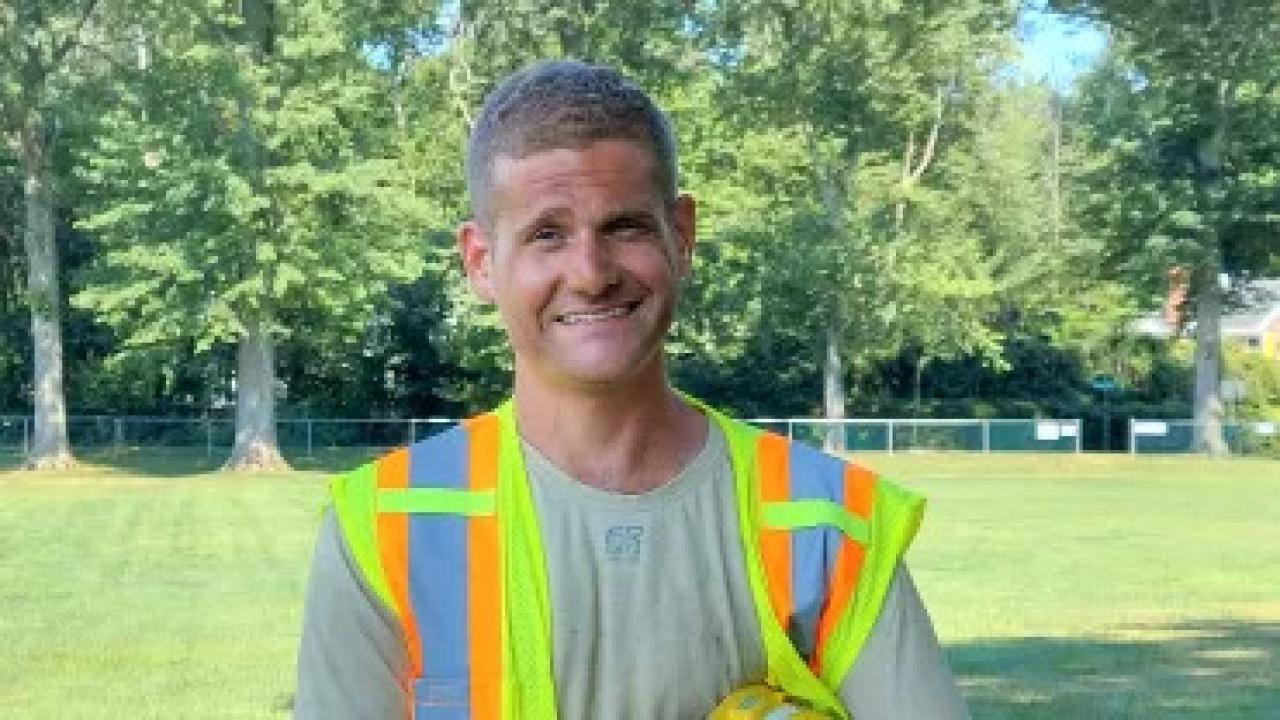 Jonathan Harmon, wearing a safety vest outside