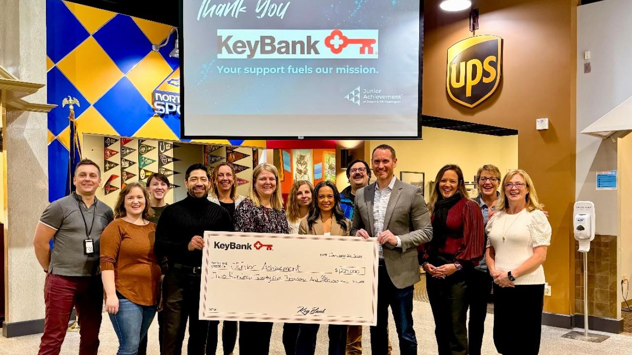 Representatives from KeyBank and Junior Achievement of Oregon shown with a $225,000 grant check.