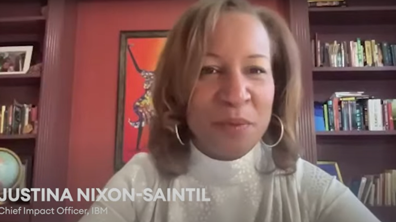 Justina Nixon-Saintil sitting in a home office setting