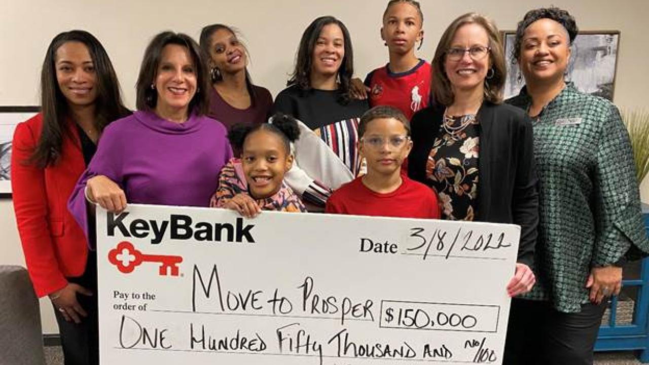 Photo caption: KeyBank Market President Lara DeLeone (second from left), along with Corporate Responsibility Officer Kenya Taylor (far right) and SVP, Service Digitization Tracie Cleveland Thomas (far left) present a grant to Move To Prosper President & CEO Amy Klaben (second from right) to support Empower 100 families (center).  