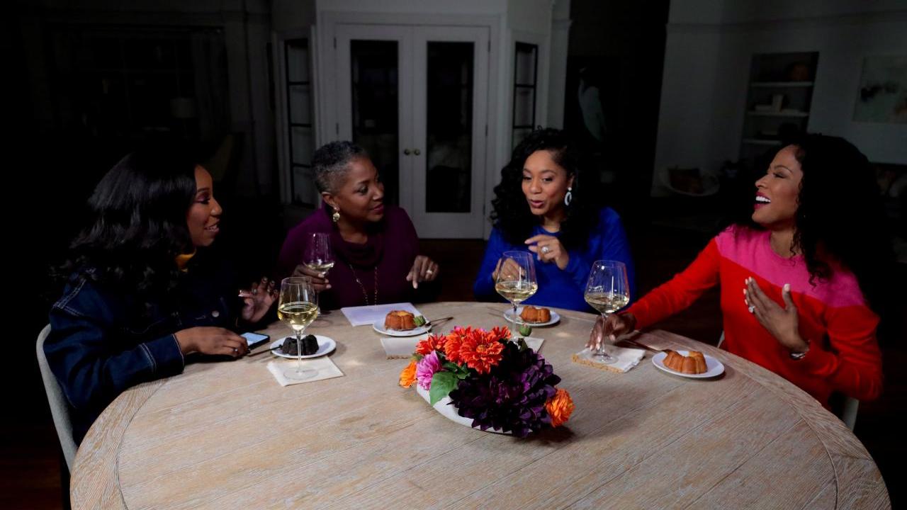 QVC Hosts Vanessa Herring, Jayne Brown, Monifa Days and Stacey Rusch are seated at a table while on-set at QVC Studios.