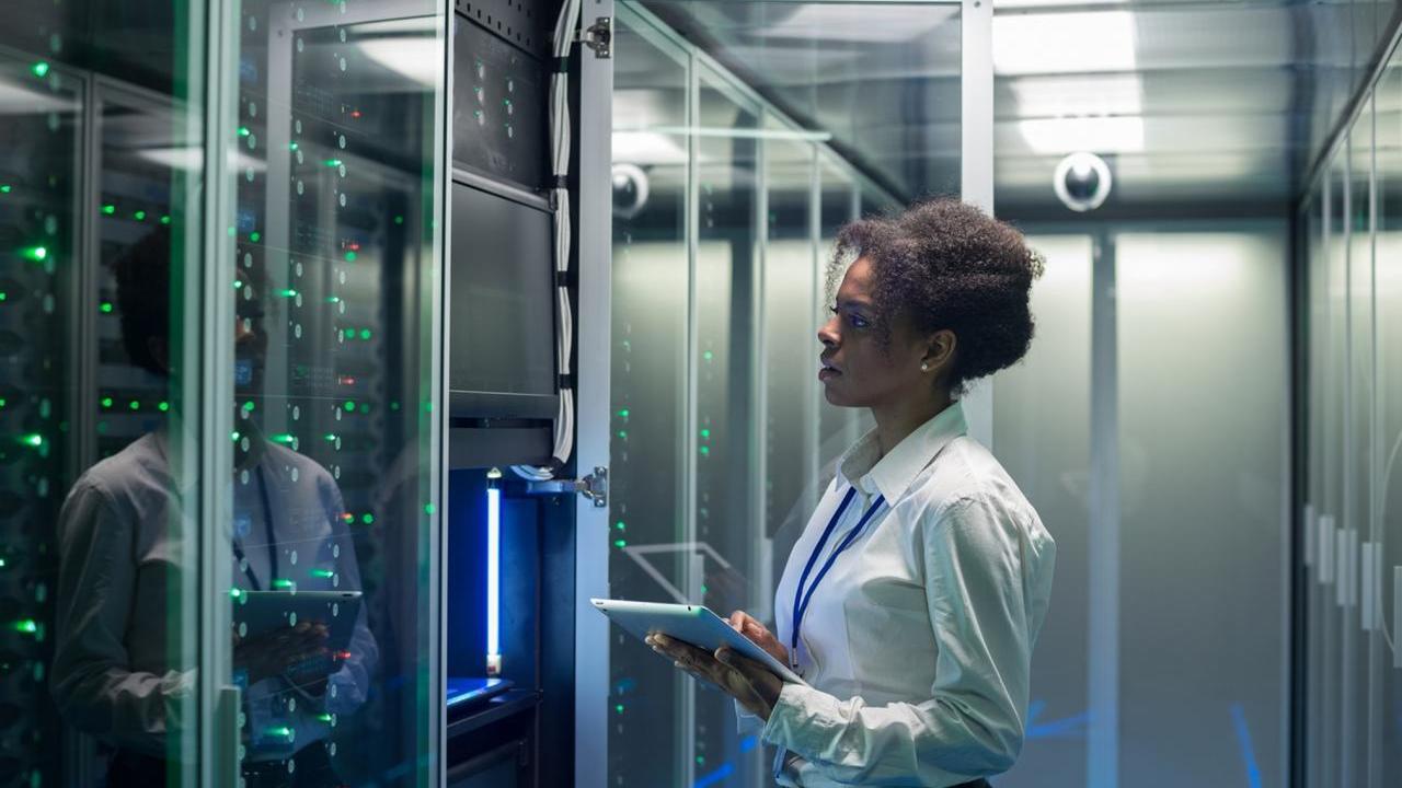 Data center worker observing servers