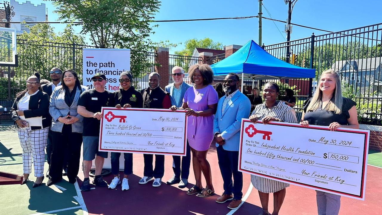 KeyBank and Keybank Foundation team members shown with grant checks.