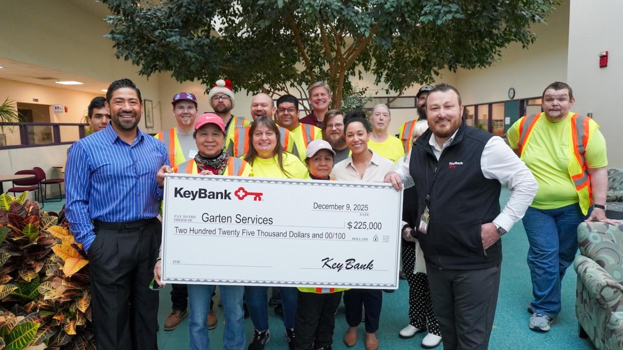 Representatives from Garten Services and KeyBank shown with  $225,000 grant check.