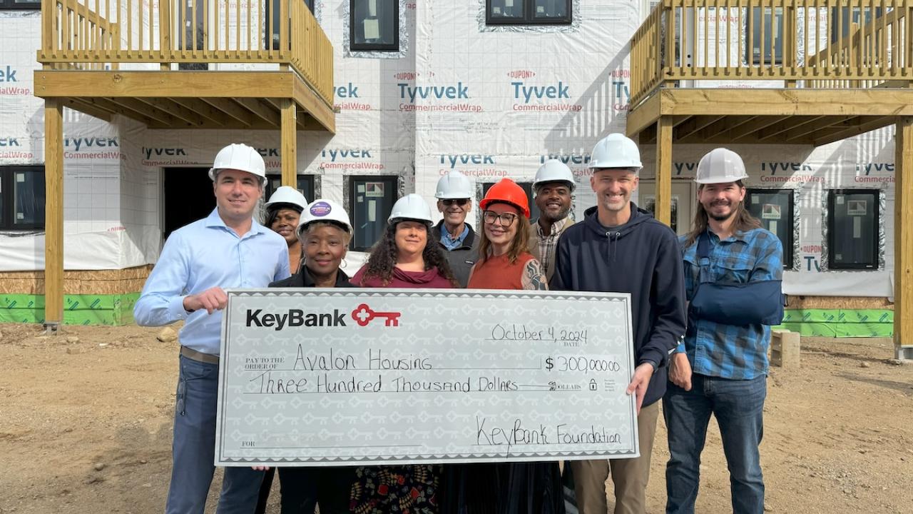 KeyBank and Avalon Housing representatives shown with a $300,000 grant check.