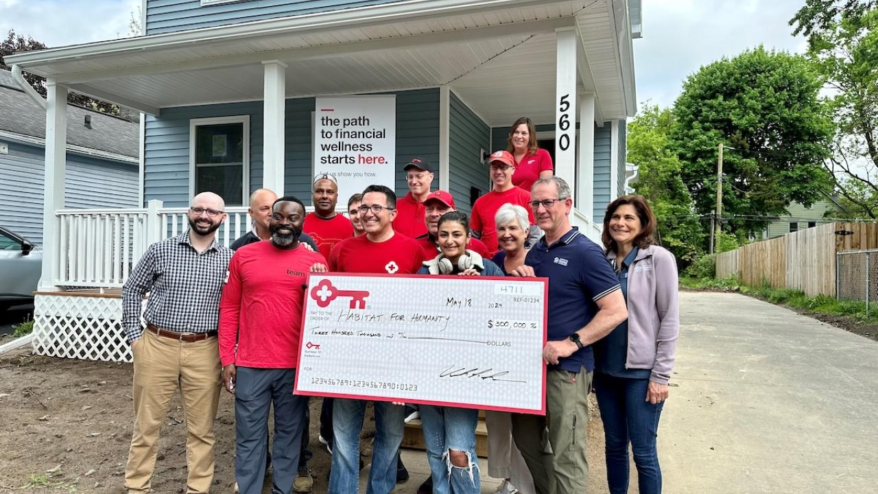 KeyBank and Rochester Habitat for Humanity team members shown with a $300,00 grant check.