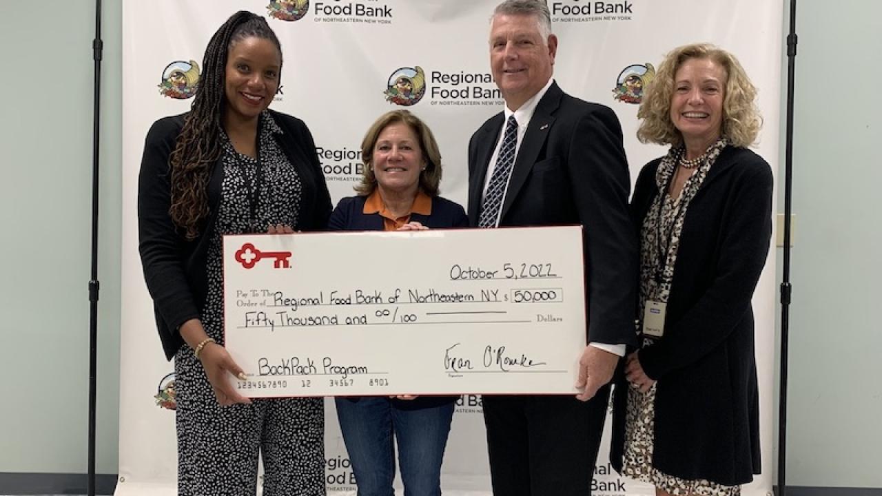 KeyBank Foundation members present a check to the Northeastern Food Bank.
