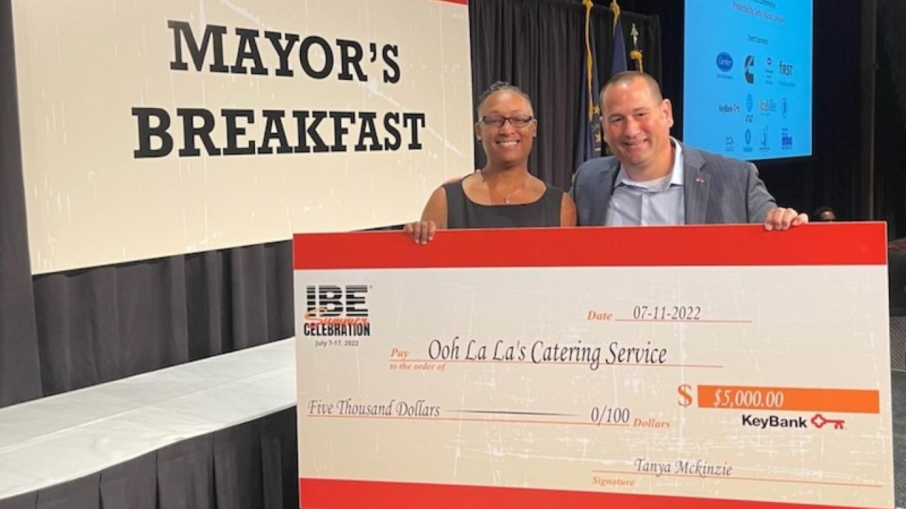 Lakeshia Peterson shown with check from KeyBank for Black Business Training.