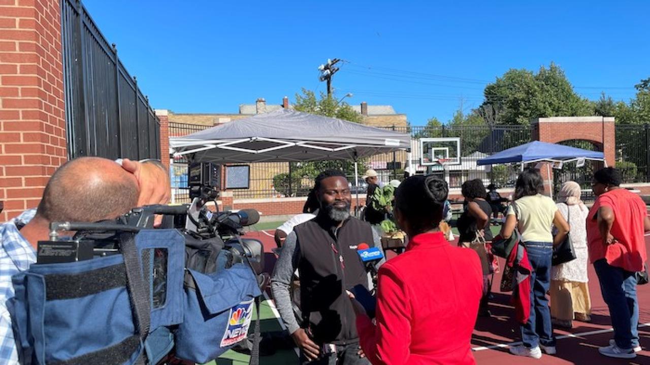 KeyBank volunteer being interviewed at farmers market.