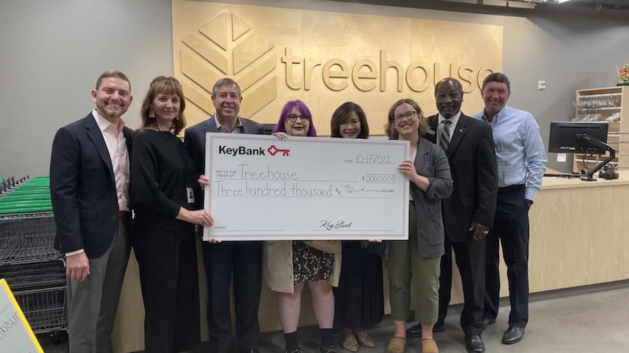 Group photo with large check