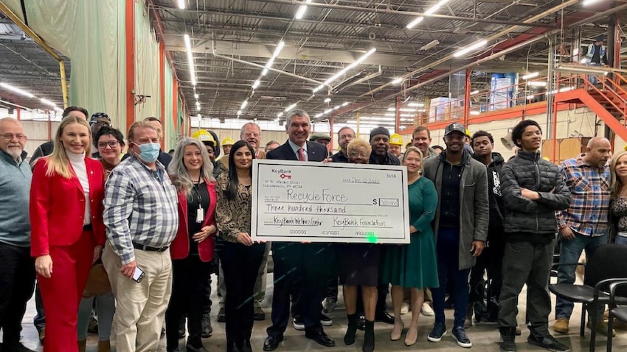 KeyBank and RecycleForce employees shown holding the $300,000 grant.