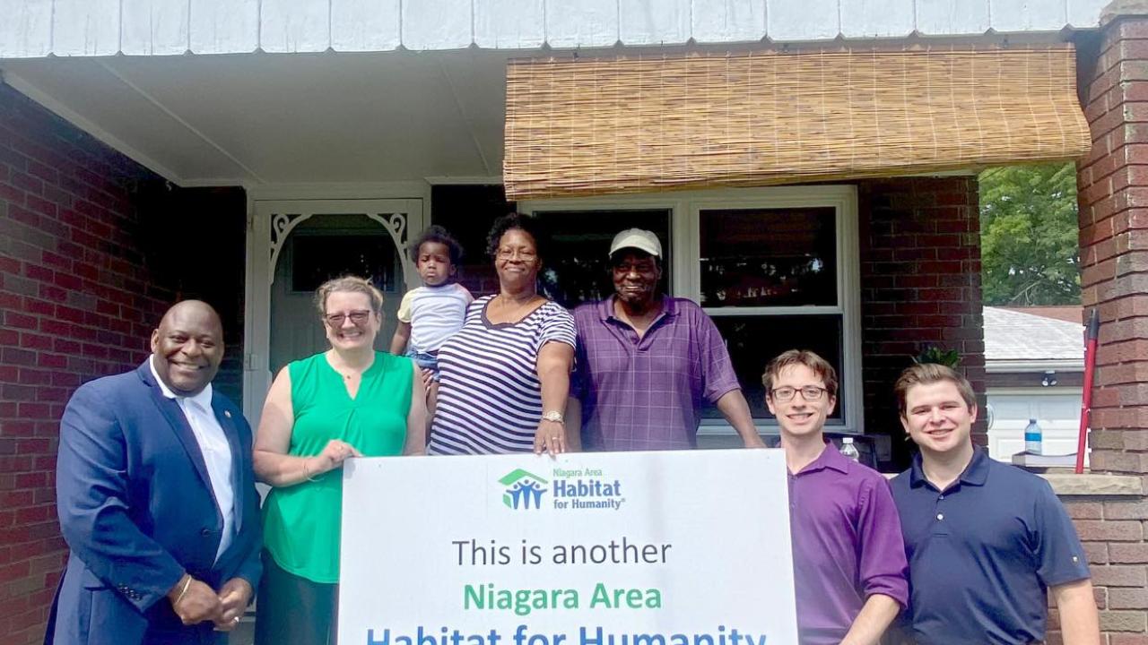 KeyBank and Habitat for Humanity team members shown in front of a home.
