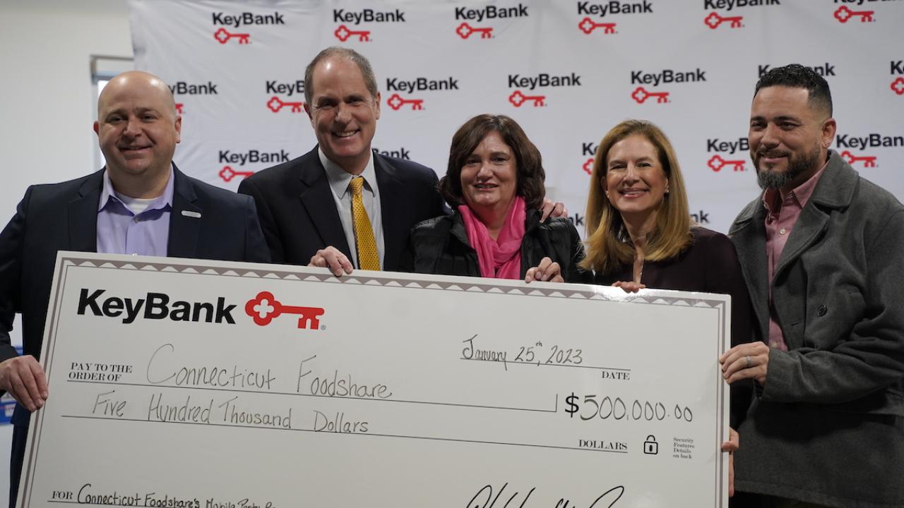 KeyBank and Conn Foodshare team with grant check.