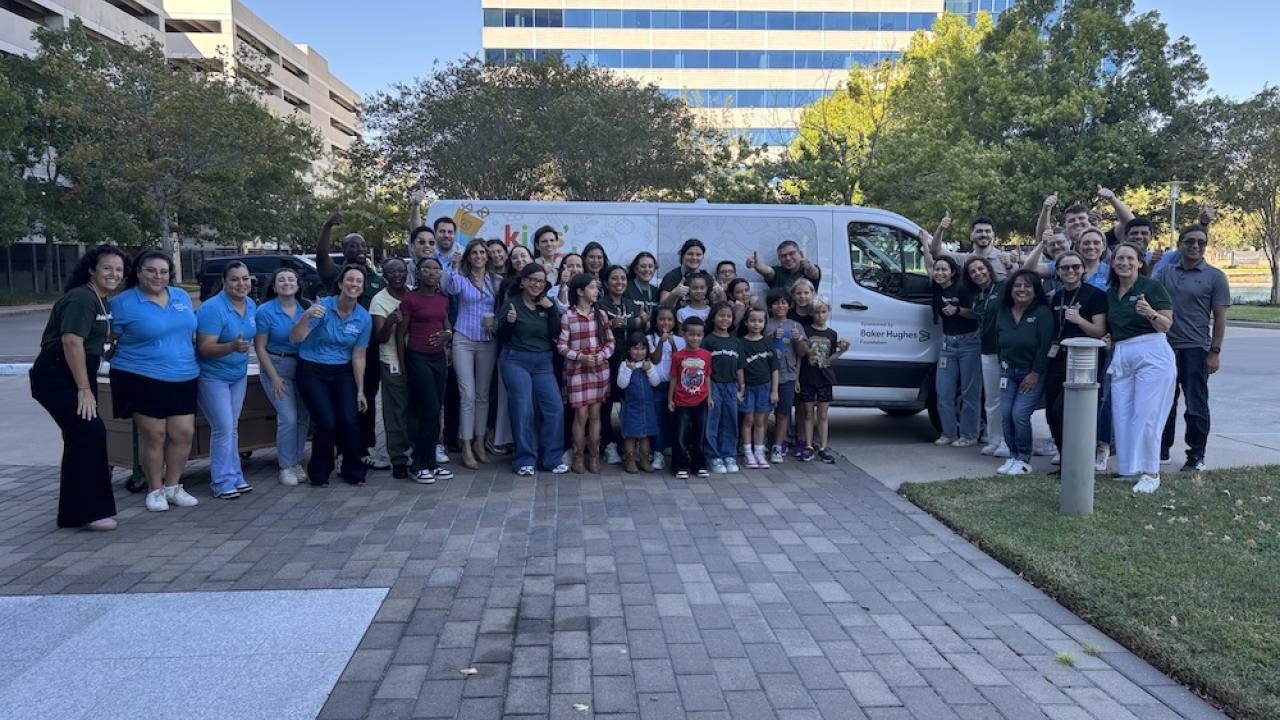 Group picture in front of the delivery van that Baker Hughes has donated to Kids' Meals