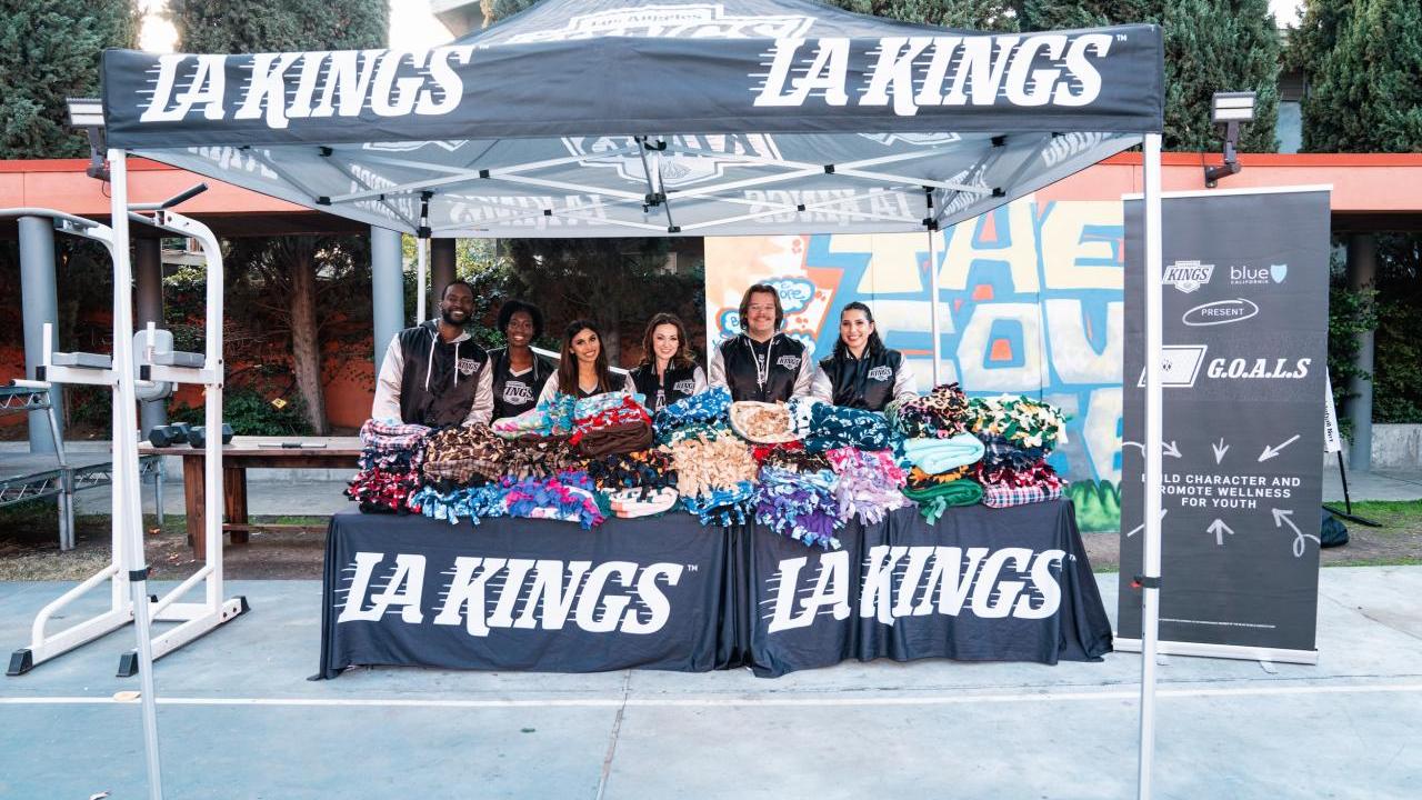 LA Kings staff distributing blankets under a tent