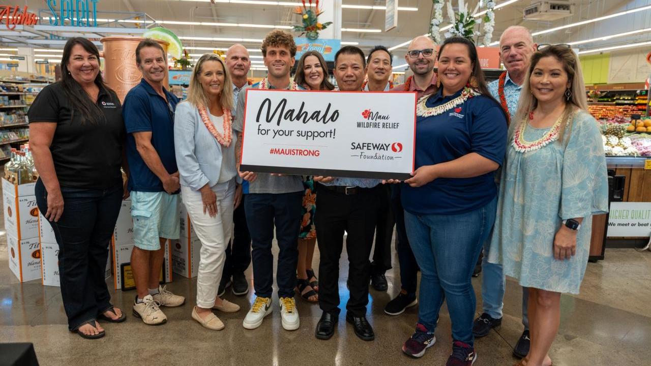 Group of people posing with check