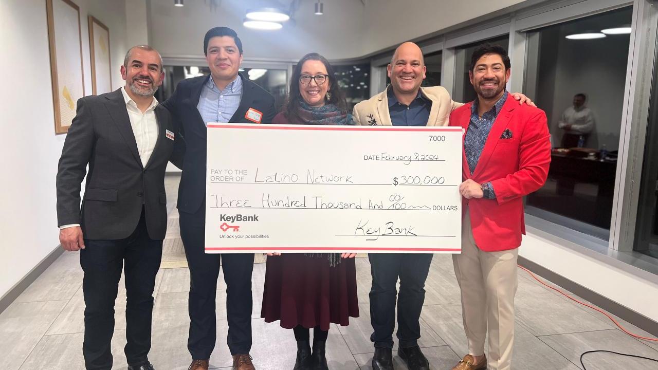 A group of people holding a cheque 