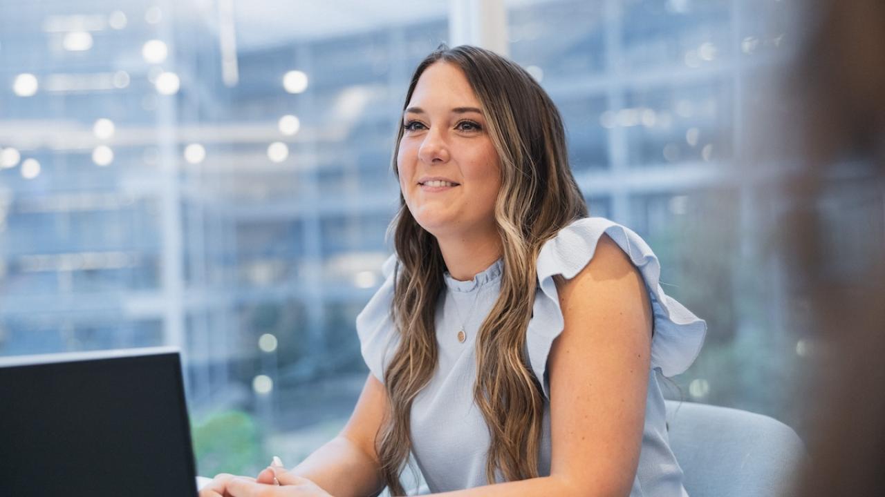 Principal employee seated in front of a laptop.