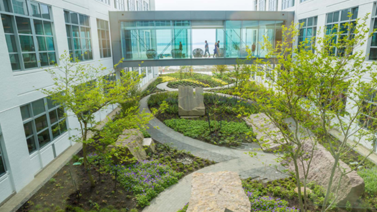 courtyard view of Expedia head quarters, a glass walkway between buildings.