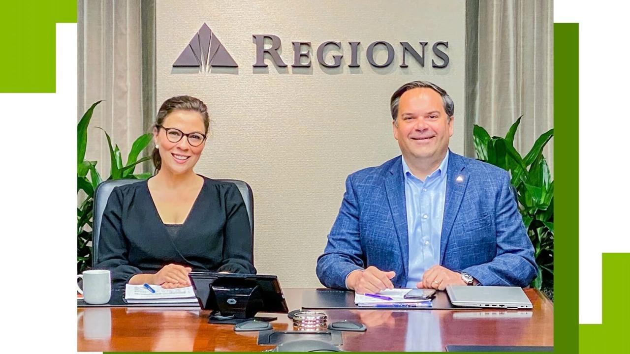 two Regions representatives in suits sitting at a polished table