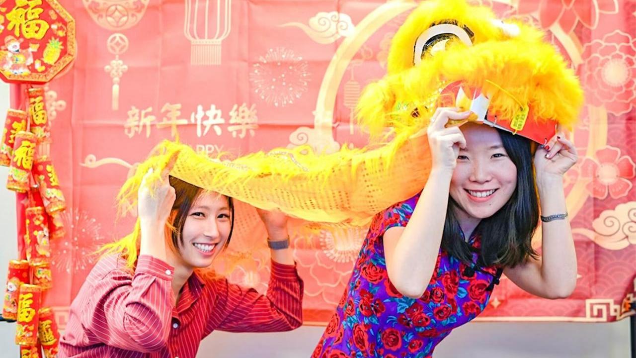 Two people holding a lion dance costume