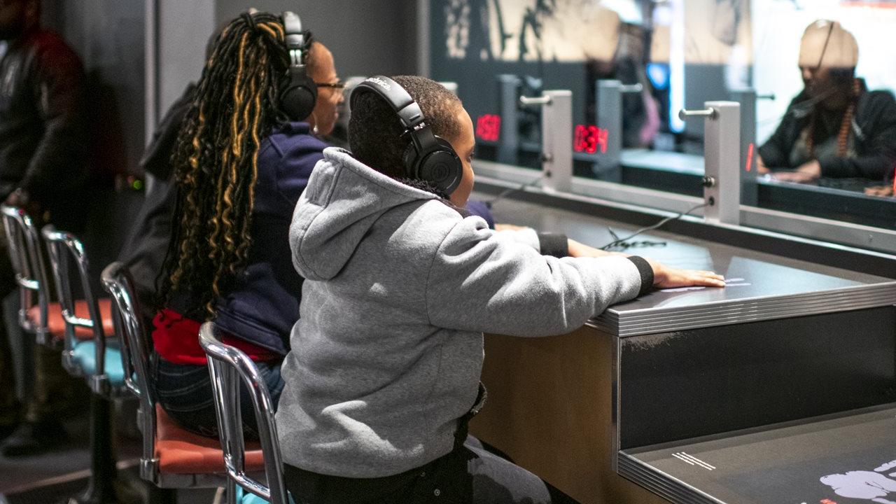 2 kids at listening stations