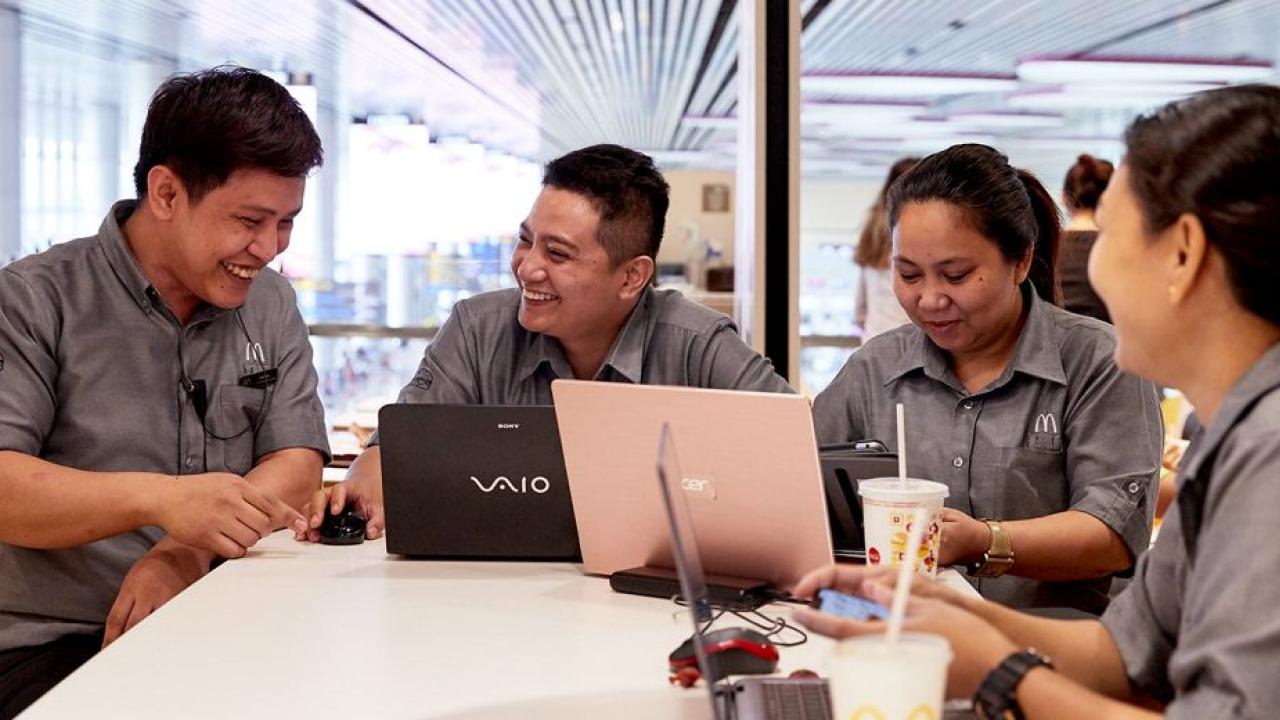 Group of staff around a table. 