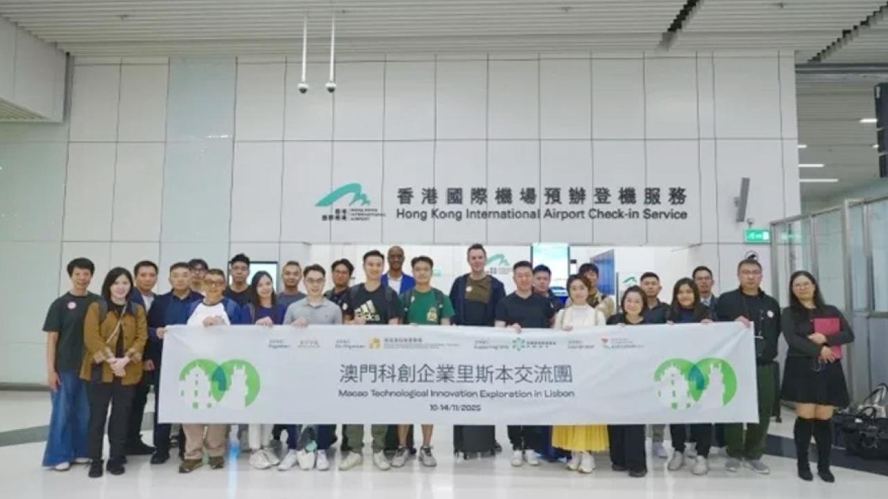 Group holding up large banner