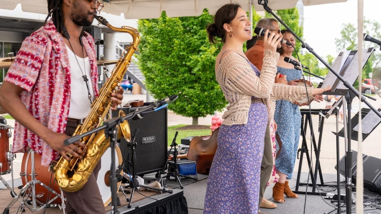 HARMAN employees onstage performing.
