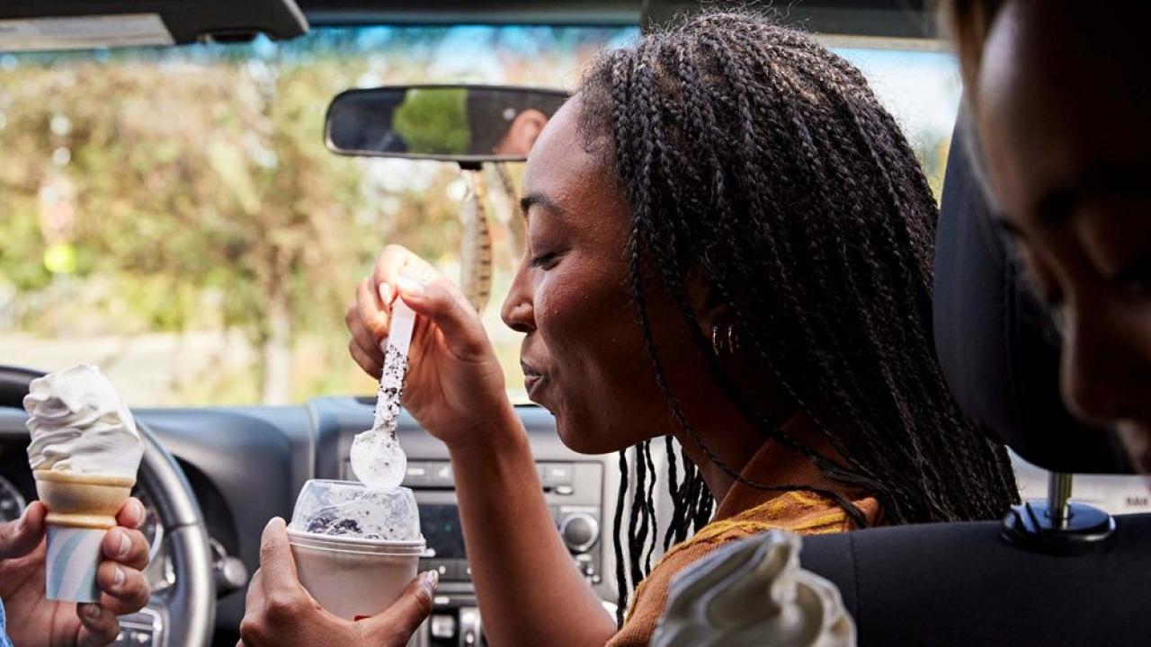 People in car eating ice cream