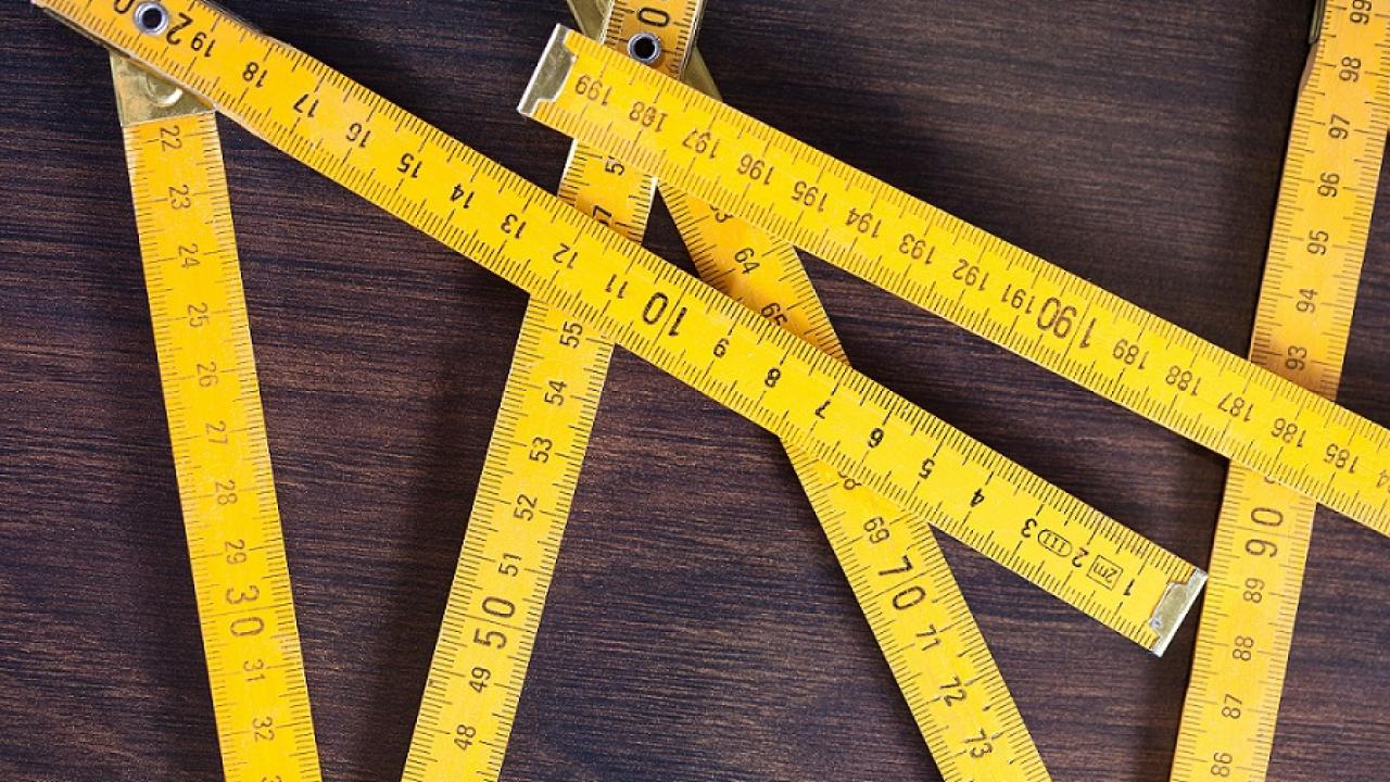measuring tapes on wooden background