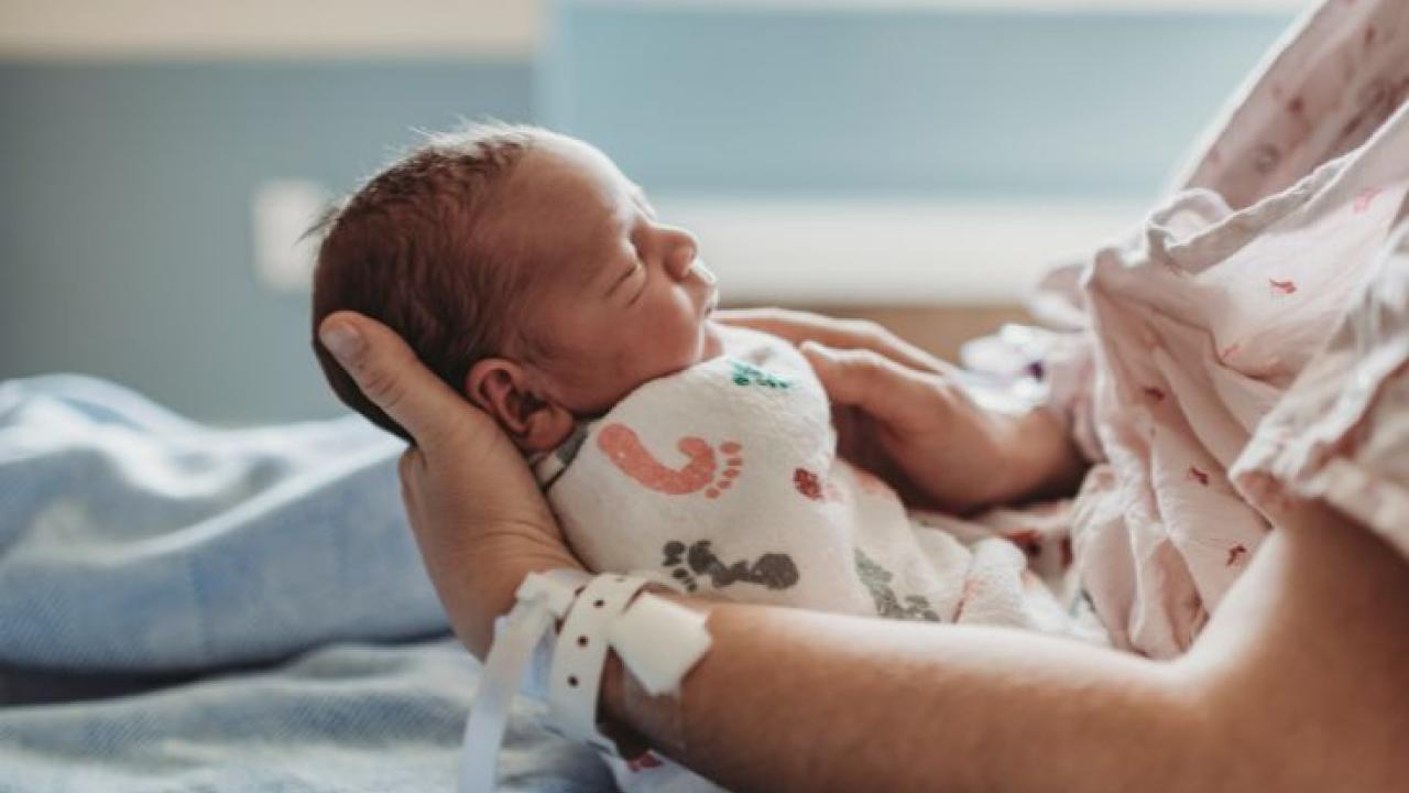 Mother holding a newborn baby.