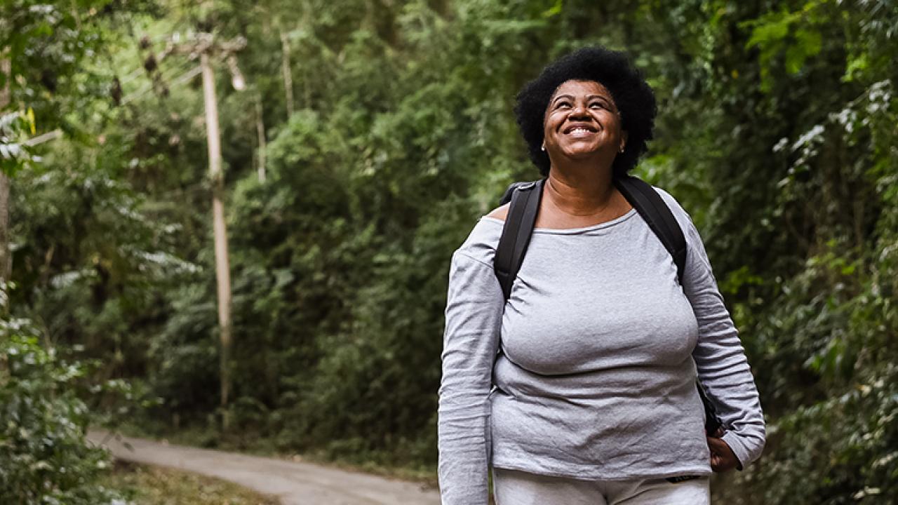 women walking through a wooded trail