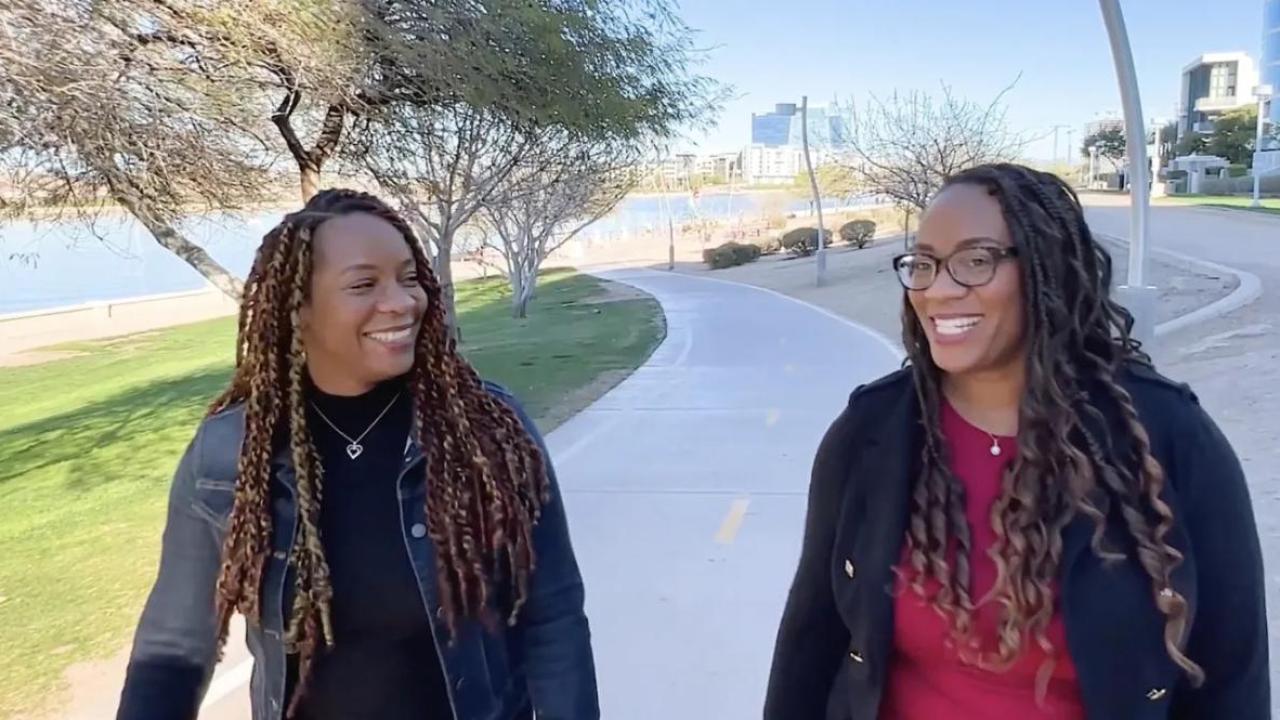 Meshawn Woods and LeShawn Parrish walking outside.