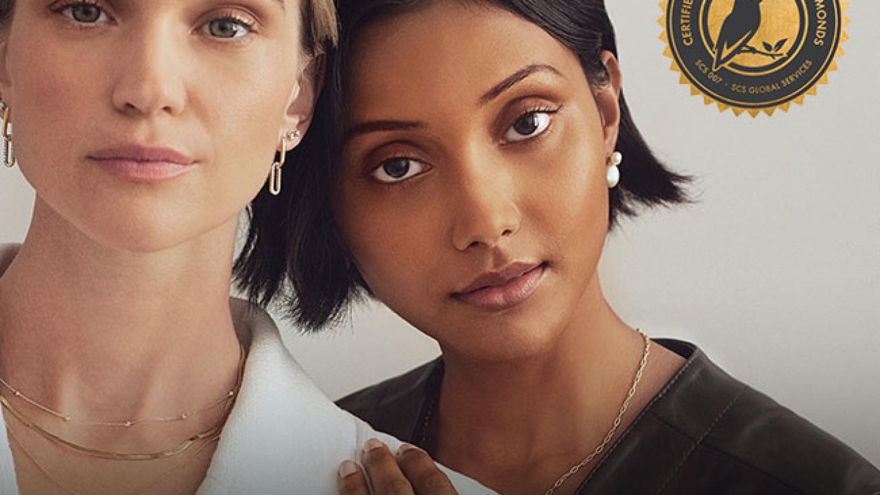 Two women wearing Michael Hill jewelry and SCS logo