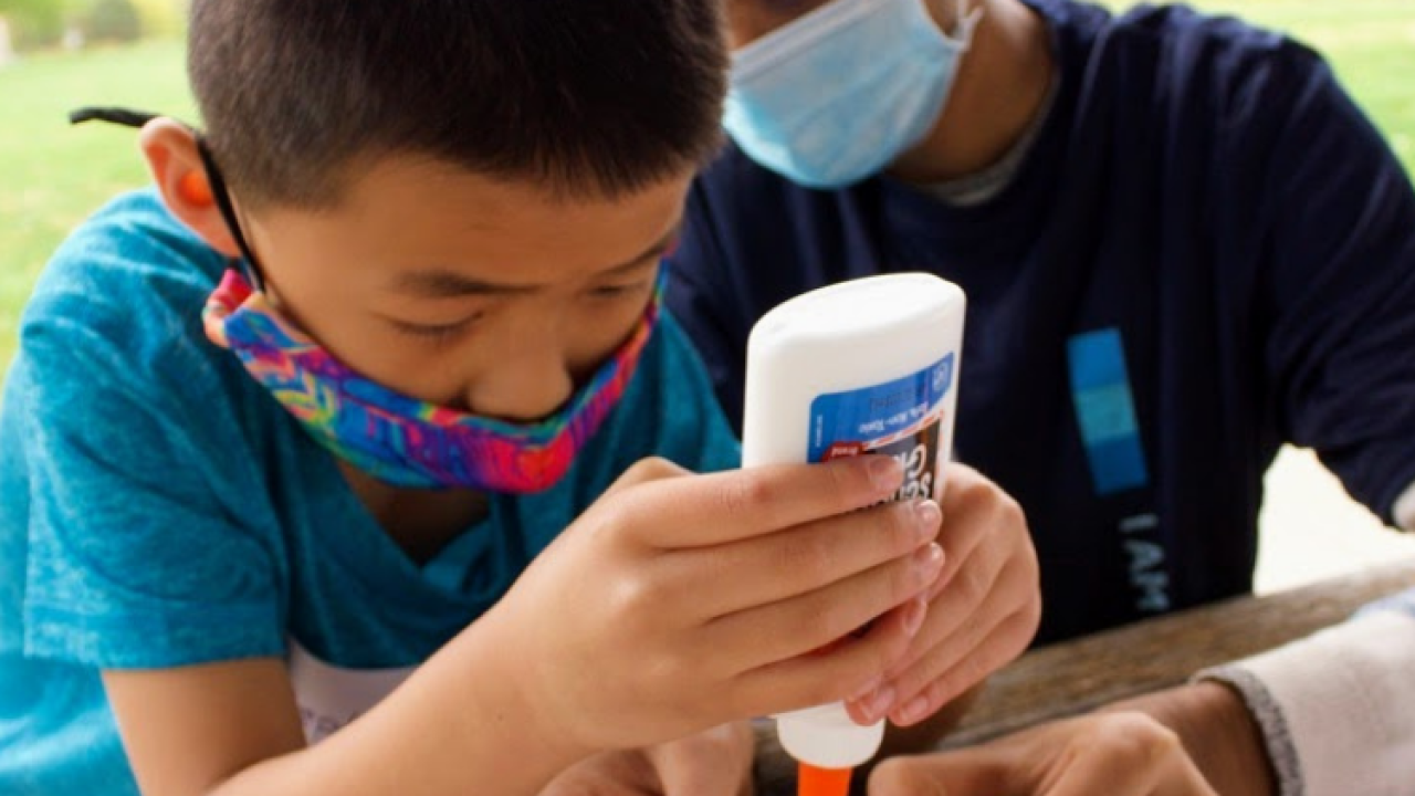 Two kids gluing a project