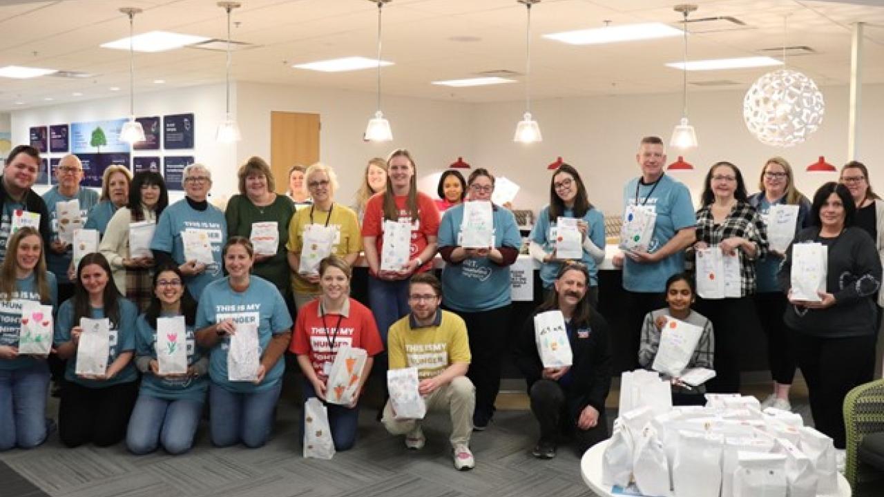 Group of people standing with snack bags