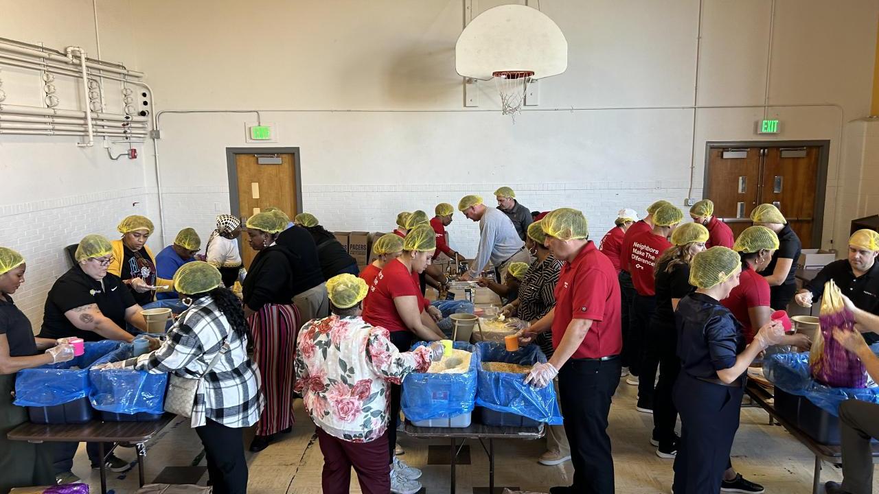 KeyBank and Edna Martin Christian Center volunteers pack meals for those in need.