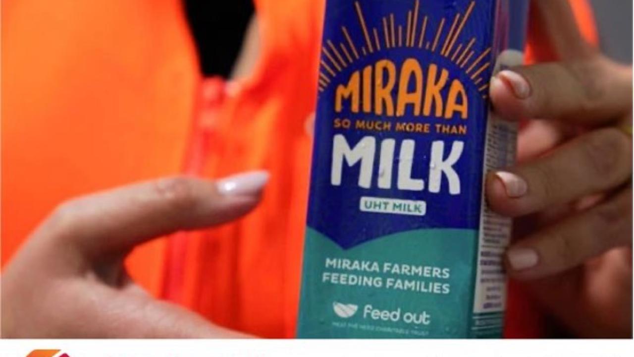 Hands holding container of Miraka Milk with Rockwell and PLEX logos below